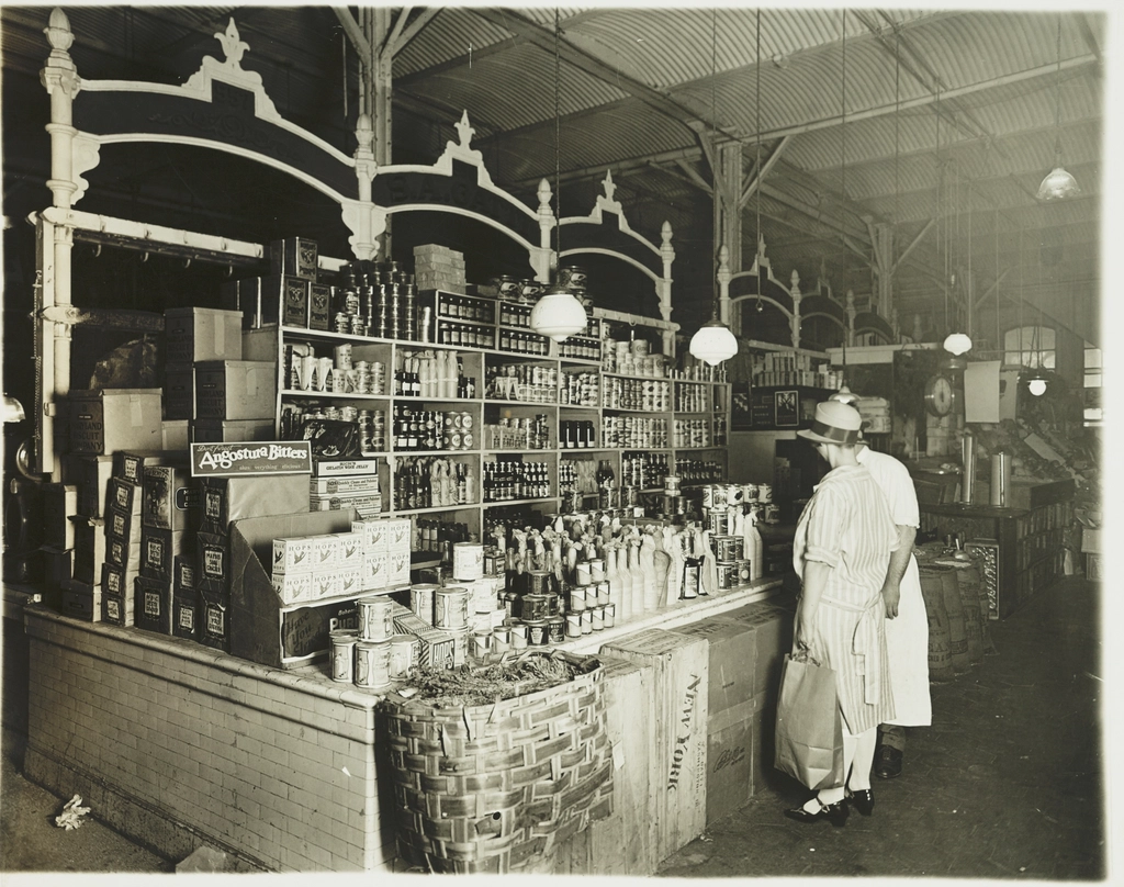 A shopper browsing grocery shelves with a basket